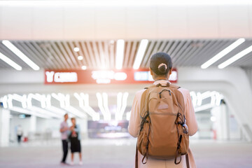 Backpacker commuter walking towards city subway station