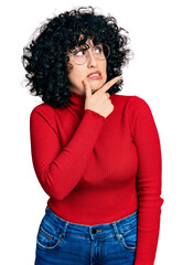 Poster - Young middle east girl wearing casual clothes and glasses thinking worried about a question, concerned and nervous with hand on chin