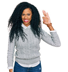 Wall Mural - Middle age african american woman wearing casual clothes smiling positive doing ok sign with hand and fingers. successful expression.