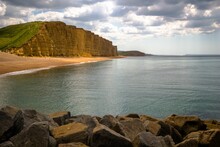 Rocky Beach With Jagged Cliffs Against A Backdrop Of A Cloudy Sky In West Bay, Jurassic Coast