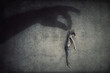 © psychoshadow - Human manipulation concept as a big hand shadow holds a powerless man hanging down as a marionette. People control supremacy and dominance metaphor