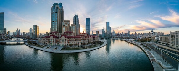 Wall Mural - Aerial shot of an urban skyline with landmarks along the Haihe River in Tianjin, China at sunset