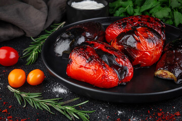 Wall Mural - Grilled vegetables in a dark plate on a stone table