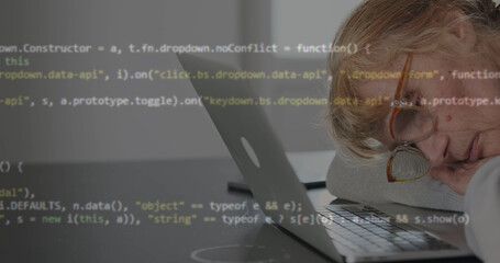 sleeping adult female programmer at her laptop. lines of script code run with projection. concept of