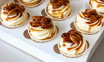 Wall Mural - Pumpkin spice caramel pecan cupcakes with cream cheese frosting