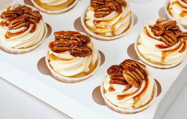 Wall Mural - Pumpkin spice caramel pecan cupcakes with cream cheese frosting