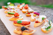 Finger food , various canapes with vegetables, ham, bacon , cheese and olives.