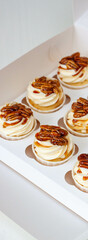 Wall Mural - Pumpkin spice caramel pecan cupcakes with cream cheese frosting