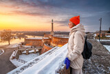 Fototapeta Paryż - In the heart of Belgrade, a woman gazes out over the city skyline, captivated by the enchanting blend of historic charm and modern vibrancy.