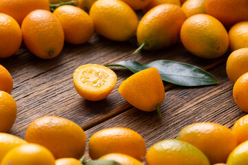 Poster - Still life of ripe kumquat fruits. Kumquat fruit top view. Background from ripe kumquat. Many kumquat fruits.