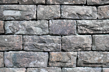 A wall made of large gray blocks. Brick gray vintage block wall.