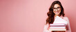 © pawczar - Happy smiling female student with glasses holds stack of textbooks books in her hands against pink background with negative copy space, back to university