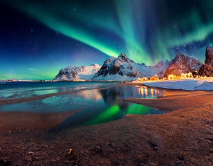 Wall Mural - Aurora borealis overlooks the sea, snow-capped mountains, and city lights at night. 