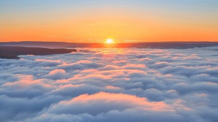 Majestic sunrise over mountains with clouds and fog in orange morning sky, a stunning landscape view