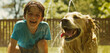 A young boy giggling with delight as he plays with his Golden Retriever in a backyard sprinkler, their laughter echoing through the warm summer air