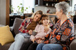 © BGStock72 - Generational bonding, grandmother, daughter, and grandchild sharing stories on a cozy afternoon