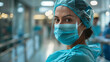 A focused nurse with a stethoscope and surgical mask stands in a hospital corridor