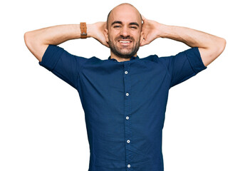 Sticker - Young hispanic man wearing casual clothes relaxing and stretching, arms and hands behind head and neck smiling happy