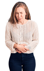 Poster - Young beautiful blonde woman wearing casual sweater with hand on stomach because indigestion, painful illness feeling unwell. ache concept.