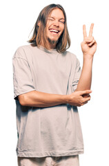 Sticker - Handsome caucasian man with long hair wearing casual clothes smiling with happy face winking at the camera doing victory sign. number two.