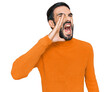 Young hispanic man wearing casual clothes shouting and screaming loud to side with hand on mouth. communication concept.