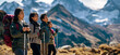 Banner with a portrait of a group of adult tourists admiring the view of the mountains while climbing, tourists holding Nordic walking poles in their hands, active lifestyle