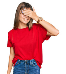 Wall Mural - Teenager caucasian girl wearing casual red t shirt smiling and laughing with hand on face covering eyes for surprise. blind concept.