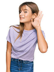 Wall Mural - Teenager caucasian girl wearing casual clothes smiling with hand over ear listening an hearing to rumor or gossip. deafness concept.