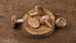 Shiitake mushrooms on a background of wood texture. Useful edible mushrooms.