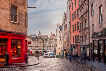 A bright red storefront and old buildings along West Bow and Victoria Street in Edinburgh Old Town, Scotland