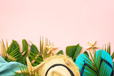Fototapeta Nowy Jork - Summer flat lay background. Palm leaves, sea shells and summer cloth on pink background.