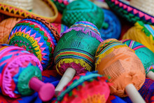 A Colorful Assortment Of Mexican Hats And Maracas. The Hats Are Of Various Colors And Patterns, And The Maracas Are Also Colorful And Have Different Designs. Concept Of Vibrancy And Cultural Diversity