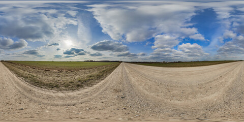 Wall Mural - hdri 360 panorama on gravel road among fields in spring evening with awesome clouds in equirectangul