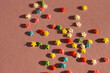 festive pink background with scattered small multicolored stars. confectionery sprinkles
