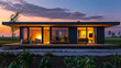 Modern minimalist prefab house at twilight with cozy interior lighting