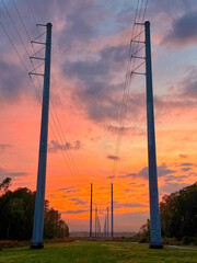 Wall Mural - Transmission lines at dusk with colorful clouds.