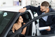© Prostock-studio - Salesman explaining car features to a woman
