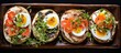 A wooden tray is displayed with four different types of food - rice cake open-faced sandwiches topped with cream cheese, veggies, and tiny quail eggs, creating a healthful breakfast spread.