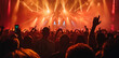 © Alina Zavhorodnii - Concert with light effects and silhouettes of people rejoicing and raising their hands in the air