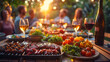 © Prasanth - Backyard dinner table have a tasty grilled BBQ meat, Salads and wine with happy joyful people on background.