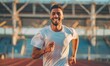 © piai - A young athletic man is jogging in the stadium