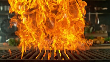 Wall Mural - Close-up of cast-iron grate with fire flames, super slow motion, filmed on high speed cinematic camera at 1000 fps. Camera movement.