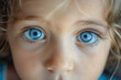 Close-up of a blonde girl child with beautiful blue eyes