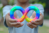 Fototapeta Mapy - Boy hands holding autism infinity rainbow symbol sign. World autism awareness day, autism rights movement, neurodiversity, autistic acceptance movement