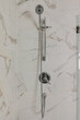 Sleek chrome showerhead assembly with adjustable settings for a personalized and rejuvenating shower experience. Pictured in a traditional cottage.