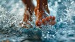 With precision, a close-up captures the intense propulsion as a swimmer's feet kick vigorously beneath the water's surface, a testament to the speed achieved in individual sports swimming.