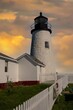 Pemaquid Lighthouse on the Maine coast in late afternoon, with a stormy sky,