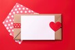 A romantic Valentine's setup with a red heart on a card and a polka dot envelope. Valentine's Theme Envelope and Card