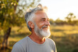 © Darya - Joyful mature man with a bright smile outdoors, feeling of happiness and enjoyment, golden hour warmth.