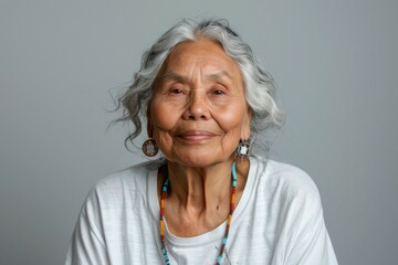 A woman with a necklace and earrings is smiling